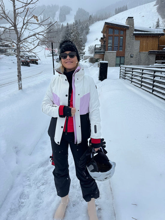 Mob wife gloves and unbottoned ski pants in Aspen.